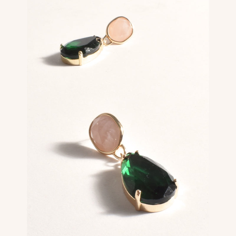 The earrings have a pink jewel stud and a green teardrop shaped jewel