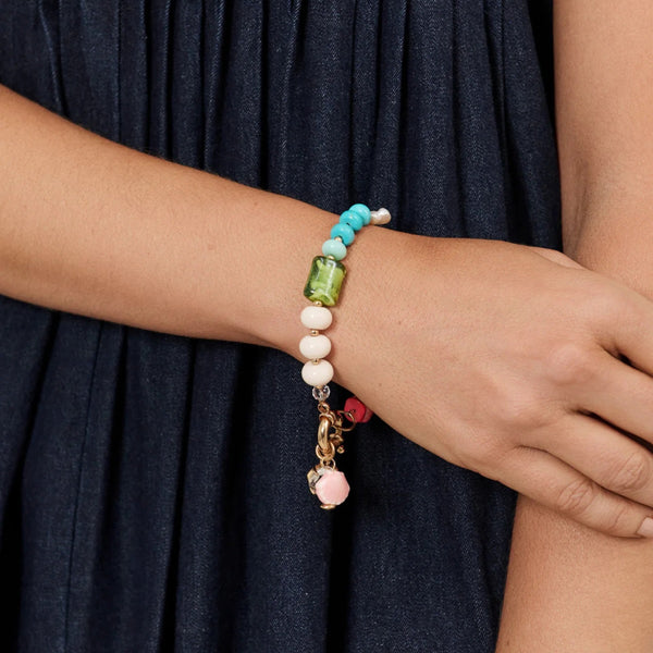 This multi coloured bracelet has a mix of stone, shells and charms.