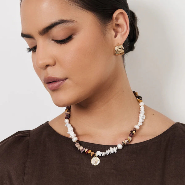Sun Charm Stone Chip Pearl Necklace in chocolate and white tones.