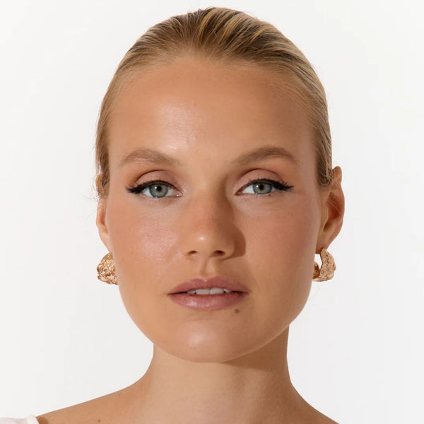Textured Curved Front Earrings - model inspo pic wearing the gold version.
