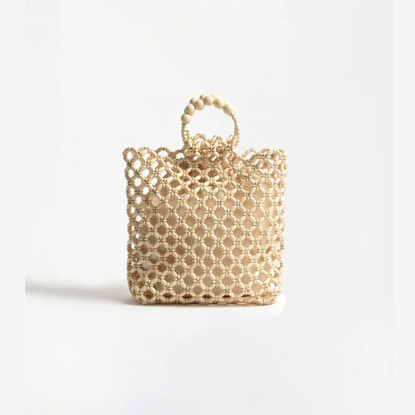This beaded basket bag in cream has lovely floral beaded accents.