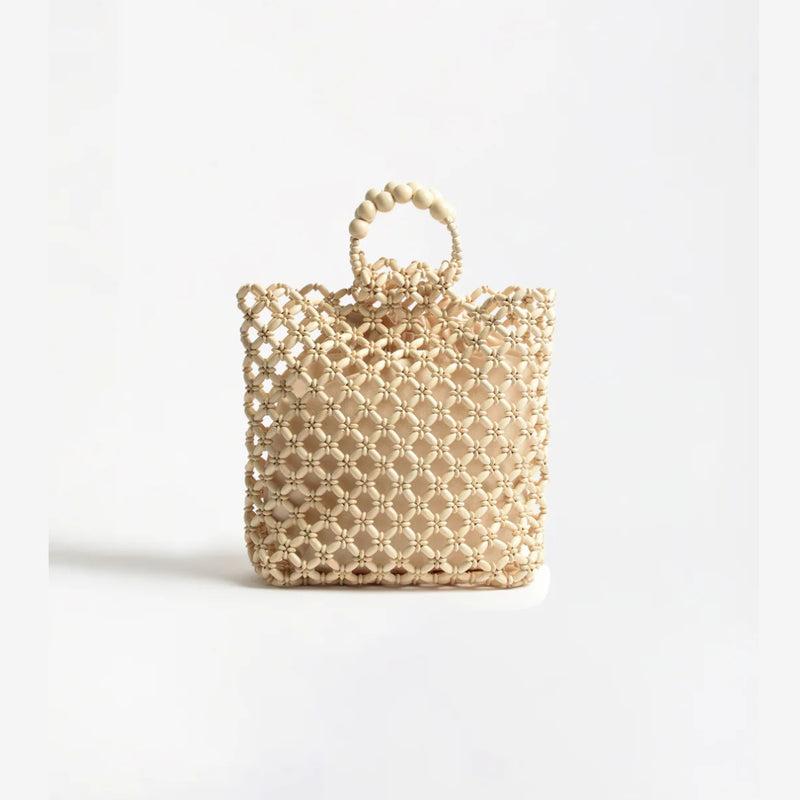 This beaded basket bag in cream has lovely floral beaded accents.