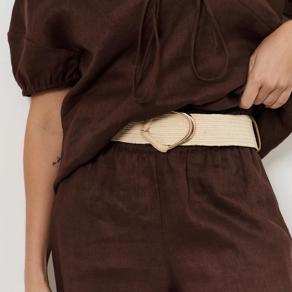 Our Wrapped Buckle Stretch Belt in natural and gold showcased on a model.