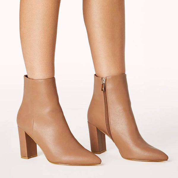 Side view of the boots which have a pointed toe and block heel