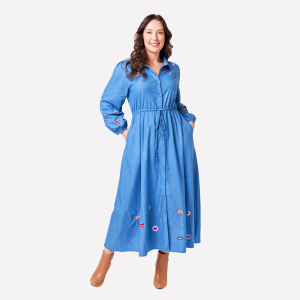 Our Joy Dress has a denim look in a lovely light blue colour and features a collar, long sleeves and a midi skirt