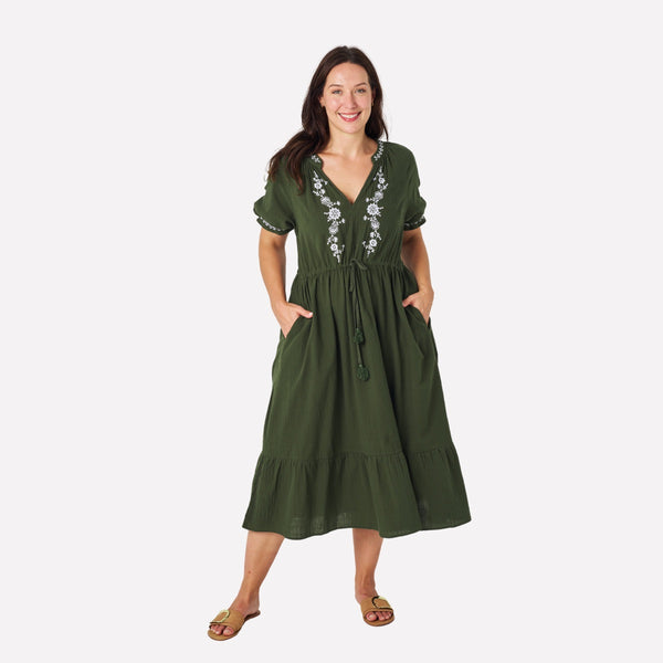 Tassah Embroidered Midi Dress in Khaki. The dress features a V neckline, short sleeves, drawstring waist and a midi length skirt with frill hem. The dress also has pockets