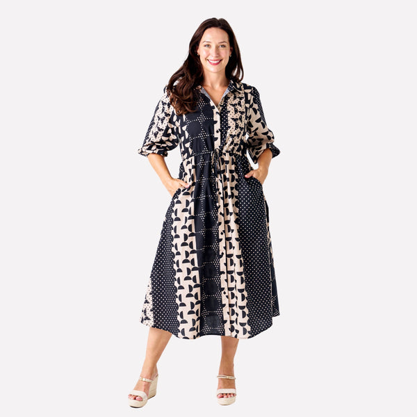 Our Zhuri Shirt Dress has a statement black and beige spotted print with contrast panels