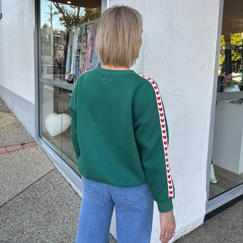 the sweater has a drop shoulder and the fab red heart accent down the sleeve.