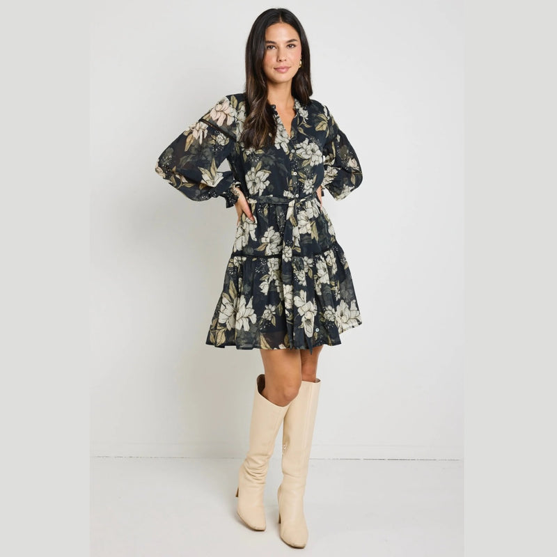 Our Script Dress has a black and cream floral print.