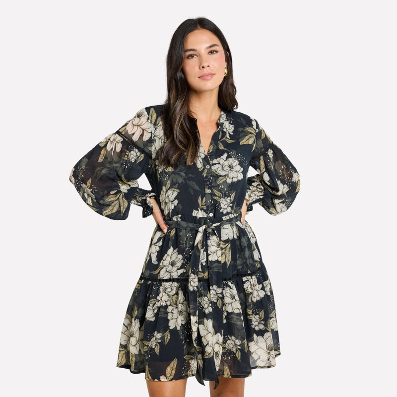 This dress features a V neckline, long sleeves, button front, detachable waist tie and a tiered skirt.