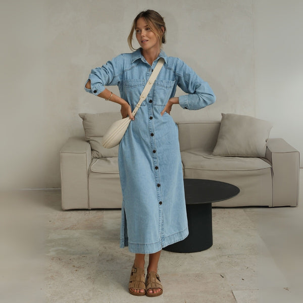 Essential Long Sleeve Yoke Denim Dress by Ceres Life. This dress has a collar, button front, long sleeves with button cuffs and it sits midi length.
