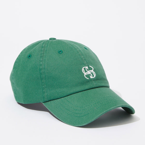 The green cap has a white monogram Ceres logo on the front.