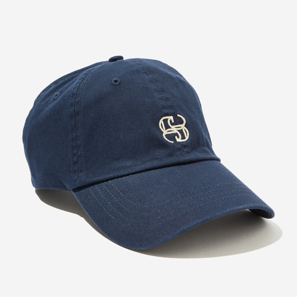 This navy cap has a monogram Ceres logo in ecru.