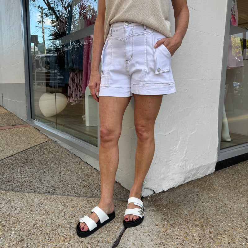 The shorts have contrast tan stitching and foldover pockets.