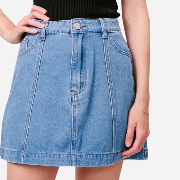 Jordan Aline Denim Mini Skirt in Blue with zip and button closure, front pockets and vertical seam accents.