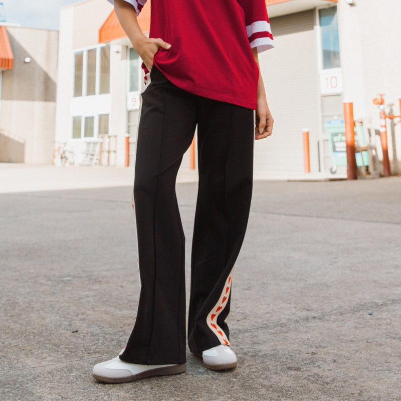 Our Everheart Pants are in a navy colour with a red heart stripe panel down each leg.
