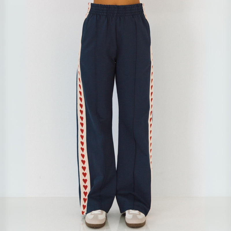 The pants have an elasticated waist and front pockets, along with a longer line straight leg.