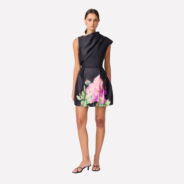 Our Azelie Dress is absolutely stunning. This black mini dress has an asymmetrical neckline and a tulip skirt with a floral motif.