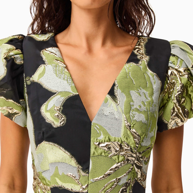 close up of the gorgeous jacquard fabrication in black, green tones with gold metallic accents.