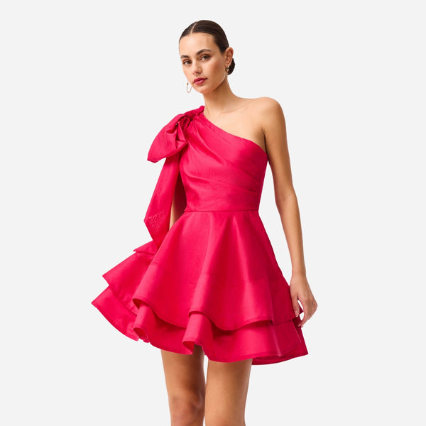 This one shoulder dress has horizontal pleat detailing on the fitted bodice and a full ruffled skirt.