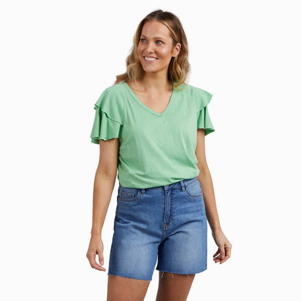 The Tulip Tee has a V neckline, short sleeves with a double frill accent