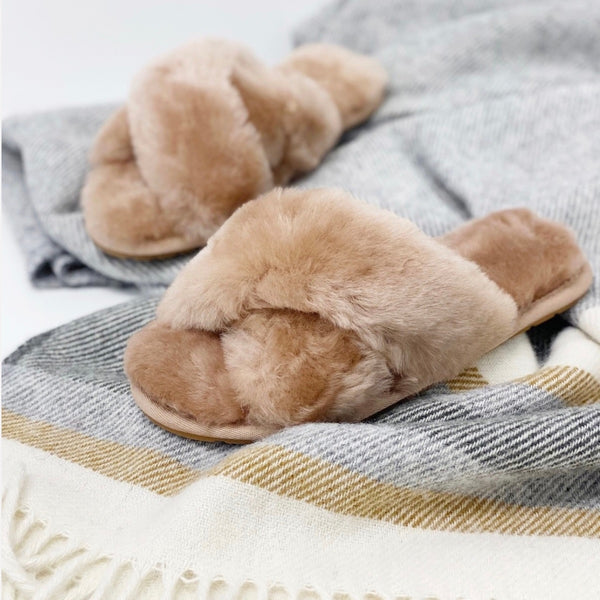These sheepskin slippers have crossover straps and are an easy slip on style.