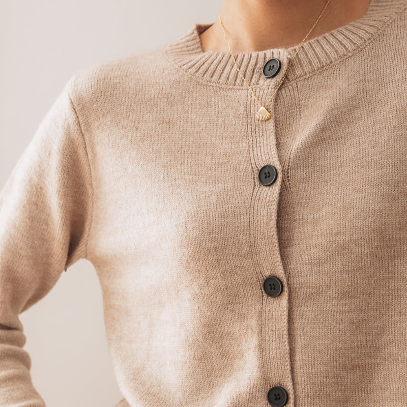 Close up of the ribbed knit and the black button front.
