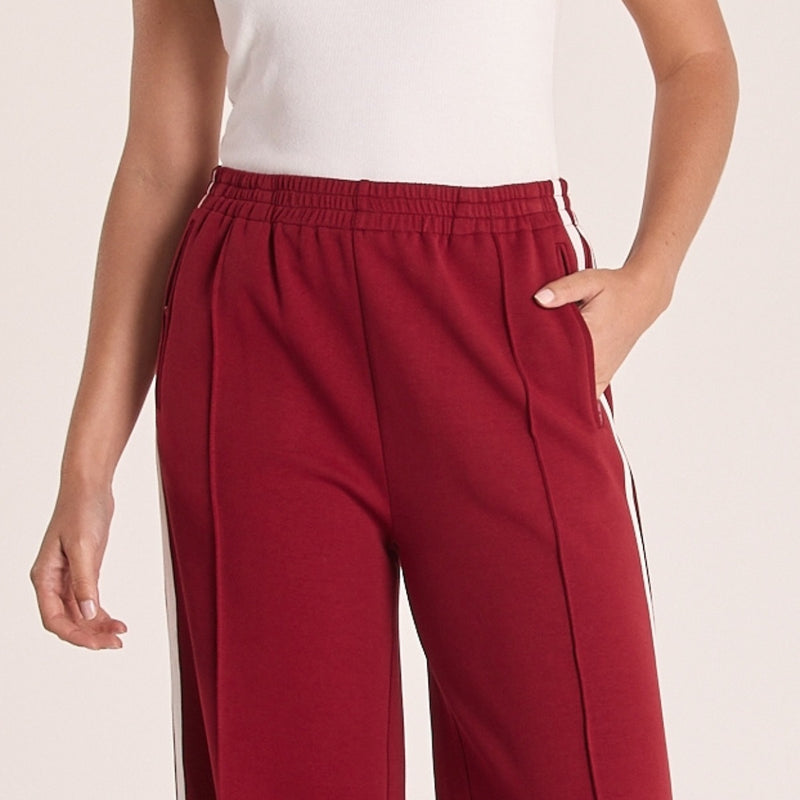 Close up of the upper front - showcasing the elastic waist, zip pockets and the pin tuck centre seam.