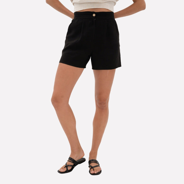 Humidity Phoebe Linen Shorts in black. They feature a flat waistband at the front with a zip and button closure.