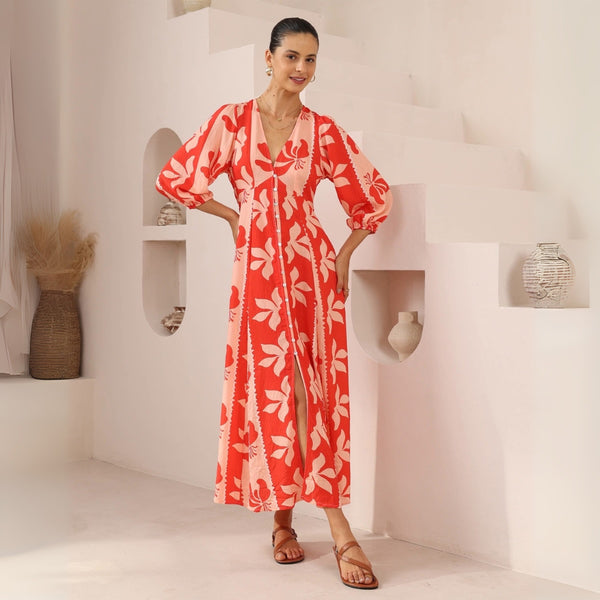 Our Cruz Dress has a colourful floral print in red and a peach colour. Features a V neckline, 3/4 length sleeves and a maxi length skirt.
