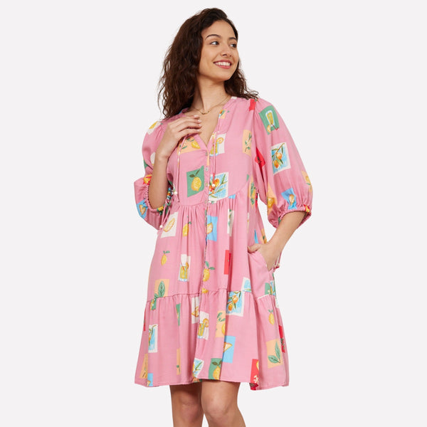 This dress has a fun tropical print with a pink base