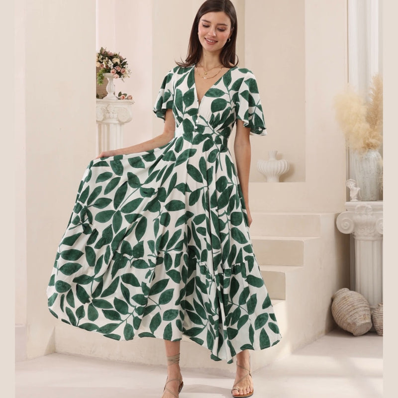 Our Jenae Maxi Dress has a striking green and cream leaf print.