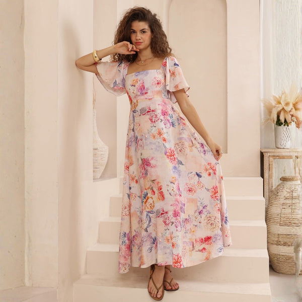 The Katie Floral Maxi Dress is a beautiful style with a muted floral print in pink, blue and purple tones.