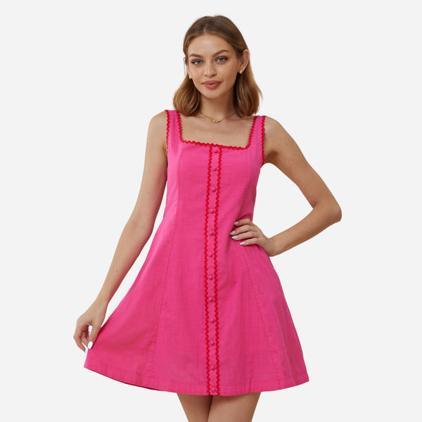 This sleeveless dress has a square neckline, faux button front and an Aline mini skirt. Features red ric rac detailing along the neckline, button front.