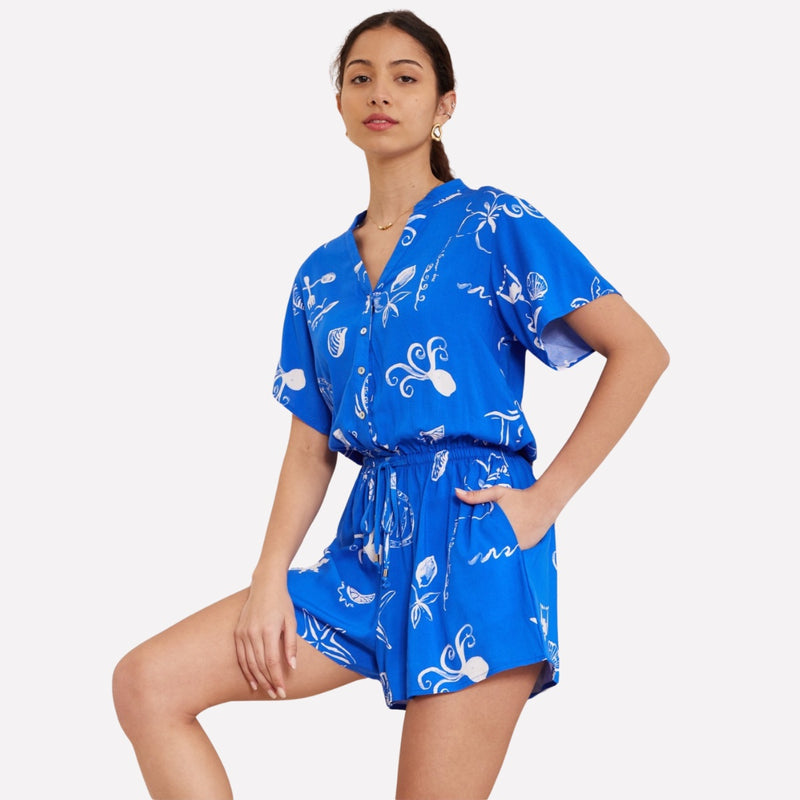 the playsuit has a button bodice, short sleeves, drawstring waist, shorts and side pockets