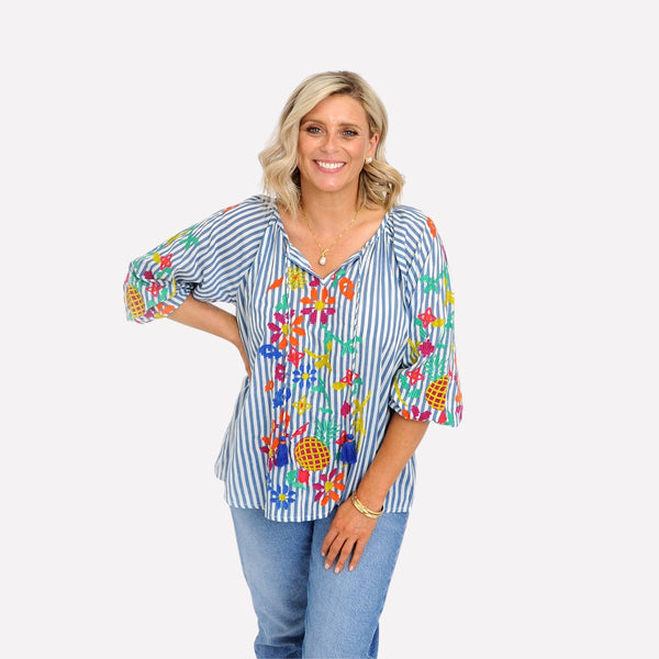 Our Birdie Stripe Top has blue and white stripes and colourful embroidery accents on the front and the sleeves.