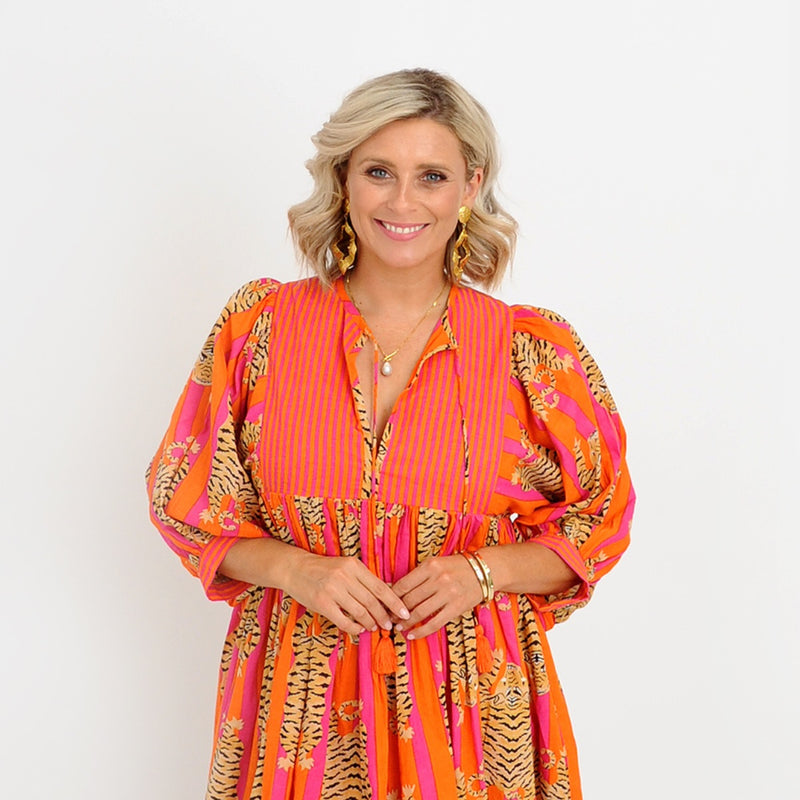 Close up of the bodice area - showcasing the neck ties finished with orange tassels and the half length sleeves.