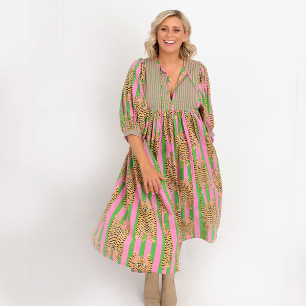 Our Jianna Tiger Dress with pink and green stripes and a tiger print throughout.