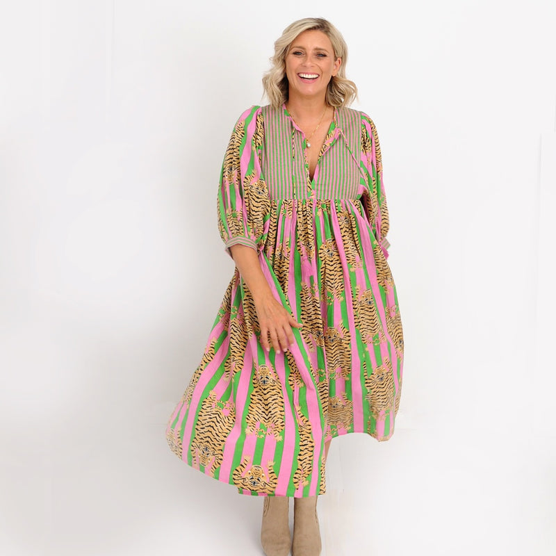 Our Jianna Tiger Dress with pink and green stripes and a tiger print throughout.