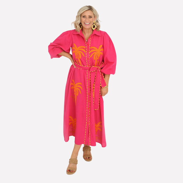 Our Paradise Palm Shirt Dress is available in a hot pink colour with bold orange embroidered palm accents on the front.