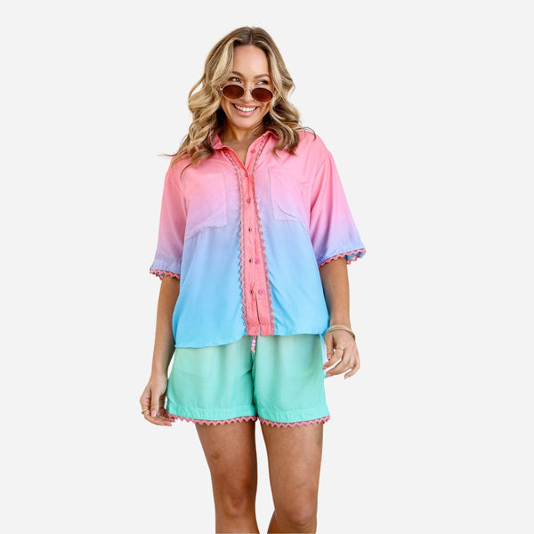 The ombre shirt ranges in colour from pink to blue (at the base) and features chest pockets.