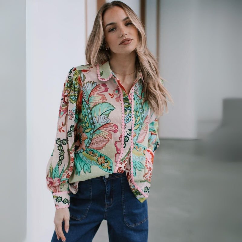Features a collar, button front, long sleeves with button cuffs.