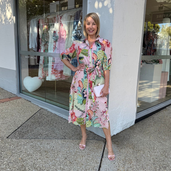 The dress has a collar, half length sleeves and a midi length skirt.