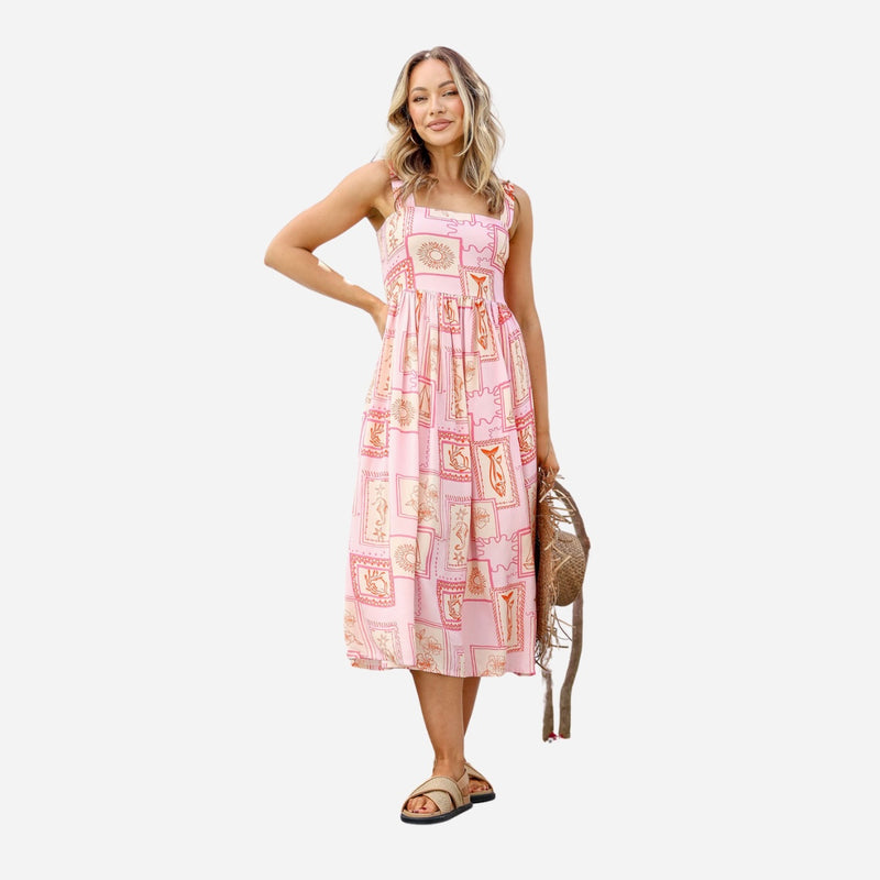 This sundress has a square neckline, shoulder straps and a full midi length skirt.