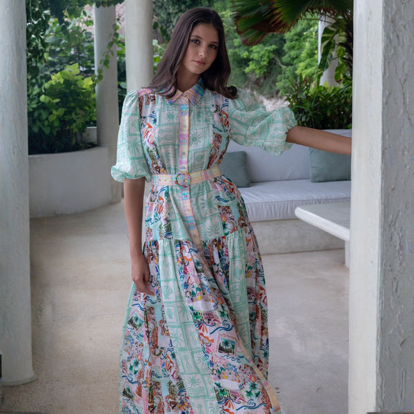 The dress has a collar, half length puff sleeves and a contrast print on the collar, button front and belt.