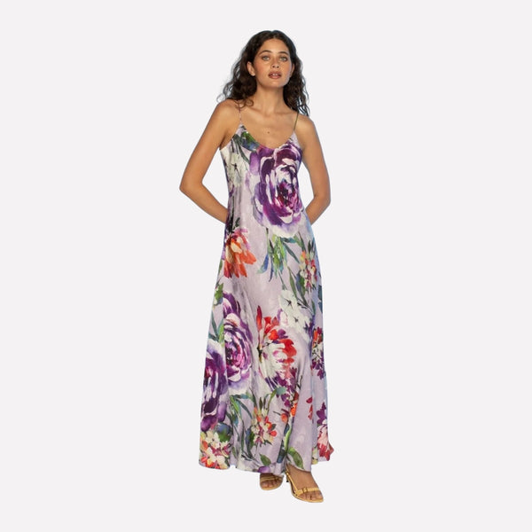 this slip dress has a V neckline at the front, spaghetti straps and a maxi length skirt.