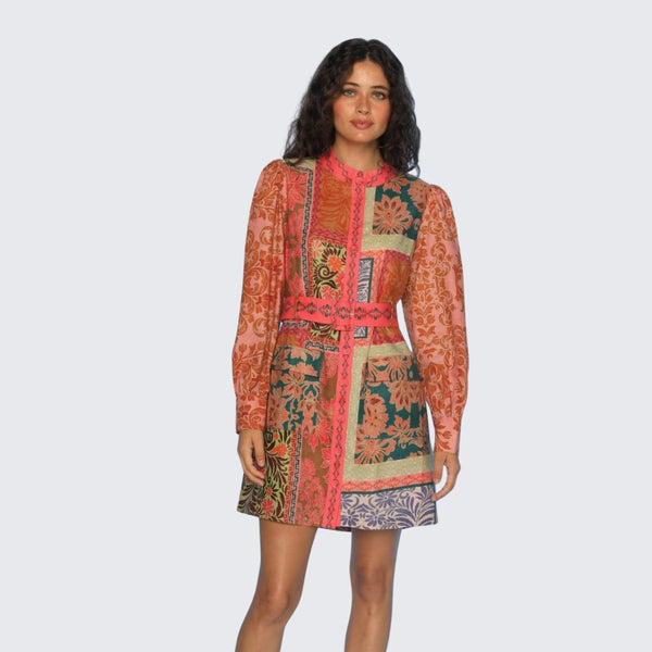 The dress has a mock collar, long sleeves with button cuffs, a detachable self print belt and it sits above the knee.