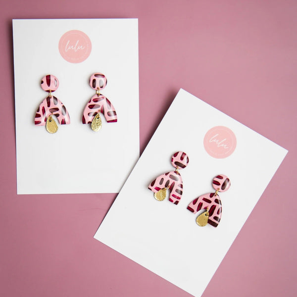 Amara Resin Dangle Earrings in pink and burgundy with a metallic gold teardrop. These resin arch earrings are lightweight.