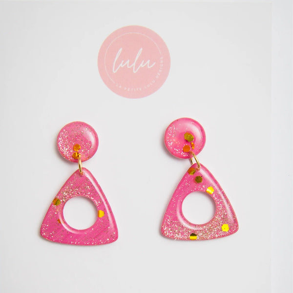 Our Triangle Resin Dangle Earrings (Rose Reverie artwork) has a triangle shaped dangle suspended from a single stud. These sparkly pink and gold earrings are lightweight.