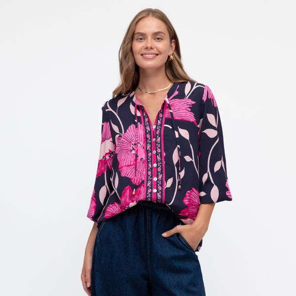 The top has an exclusive navy, white and pink floral print.
